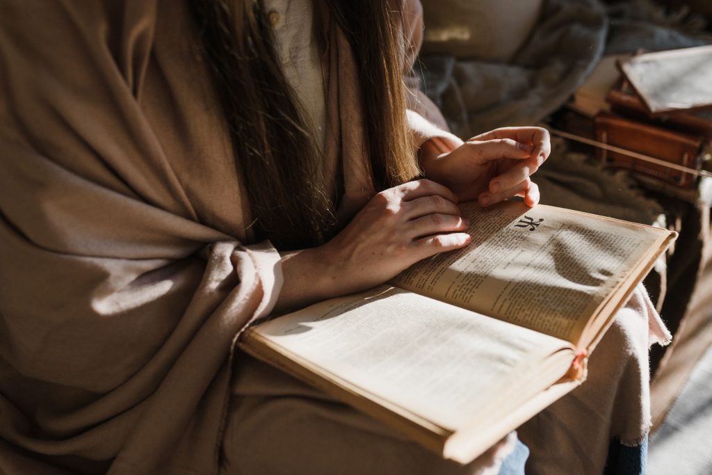 дівчина читає книгу про християнство